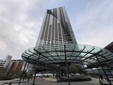 ザ東京タワーズシータワー 下層部にガラス製のキャノピーを備えたモダンな高層タワーの外観