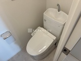 アーバネックス浅草橋フロント 温水洗浄便座付きトイレと手洗い器が備わった清潔感のあるトイレ