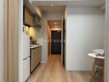 リビオメゾン浅草雷門 木目調のキッチンと奥行きのある廊下が一体化した開放的な室内空