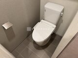 リビオメゾン浅草雷門 温かみのあるトイレ空間にウォシュレット付きトイレが備わる様子