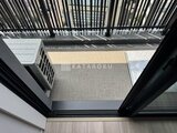 シーズンフラッツ大森北三丁目 縦格子のルーバーから光が差し込むバルコニーの様子