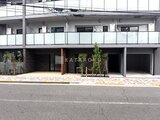 ドゥーエ三ノ輪3 前面道路から見た建物の1階エントランス、植栽が配された開放的