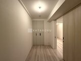 パークアクシス品川シーサイド 明るい廊下に収納扉とリビングダイニングへの開口部が並ぶ様子