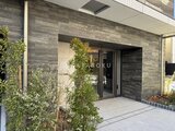OAKLANCE森下2 モダンな石貼り外壁とガラス引き戸のエントランス