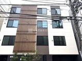 THE PALMS大島 木目調パネルと白壁を組み合わせたモダンな建物外観