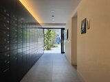 リビオメゾン浅草橋 モダンなメールボックスが並ぶ明るい共用廊下から外部へ続く通路