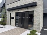 エスレジデンス千住大橋ブロード モダンな石積み調の外壁とダークカラーの引戸が印象的なエントラ
