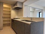 クラリティア上野稲荷町 モダンな色合いのキッチン、左手には収納たっぷりのパントリーが