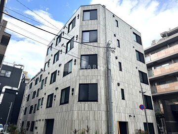 ES-Grande門前仲町デュオ 石貼りの落ち着いた印象の角地に建つマンション外観