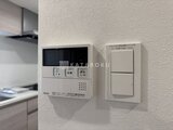 アーバンパーク船堀2 キッチン壁面に設置されたガス給湯器の操作パネルと照明スイッチ