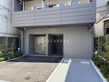 プライムブリス本所吾妻橋 モダンな外観の建物1階エントランスと庭空間の様子