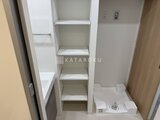 リージア代々木ビナリオ 棚付きの洗面化粧台と洗濯機置き場がある明るい洗面室