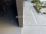 デュオフラッツ大森イースト 駐車場から見た建物エントランス前の駐車枠と植栽スペース