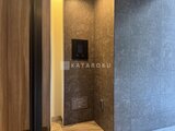 デュオフラッツ大森イースト 間接照明と濃いめのタイル貼りの落ち着いた玄関ホール