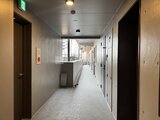 コンフォリア・リヴ文京千駄木 複数の住戸が並ぶモダンな共用廊下の様子