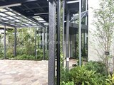 パークアクシス五反田スカイタワー 緑に囲まれたモダンなテラス空間と石張りのアプローチ
