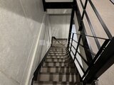 ウェルスクエア幡ヶ谷 モダンな手摺りが付いた階段室の上階方向への眺め