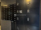 グランカーサ上野松が谷 夜間に照らされたモダンなエントランスの集合ポスト