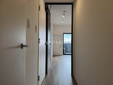 シーフォルム板橋3 モダンな黒枠ドアと明るい廊下から奥の居室を見た様子