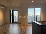 ラペルラ目黒東山2 開放的な窓から市街地を望むリビングダイニング