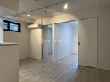 ラヴィエール住吉駅前 明るい照明と広々としたフローリングの居住空間を見渡した様子