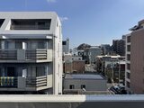 アルコバレーノ亀戸2 モダンな外観の建物と周辺の街並みを見下ろした眺望