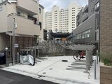 ラヴィエール新板橋 駐輪スペースと駐車場を備えた開放的な敷地入口の様子