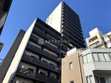 ラティエラ武蔵小山レジデンス 緑の植栽を配した開放的なエントランス前の道路景観