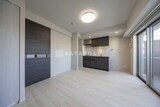アリビス綾瀬 開放的なリビングダイニングと黒を基調としたキッチンの様子