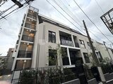 クレストコート東池袋 モダンなデザインの建物外観と植栽が調和した前面道路からの眺め