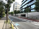 パークマンション檜町公園 街路樹に囲まれた前面道路から見た建物外観