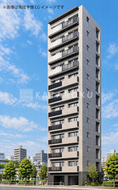 パークレジデンス小石川 青空を背景にした、落ち着いた色合いの縦長マンション外観