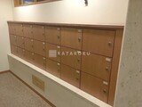 オークヒルス 木目調のメールボックスが整列した共用部の様子