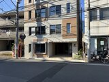 デュオメゾン西新宿 前面道路から見たモダンな外観と開放的なエントランスの様子