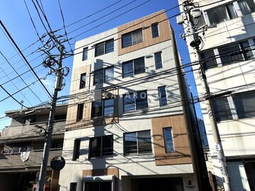 デュオメゾン西新宿 木目と白を基調とした縦長のモダン建物外観