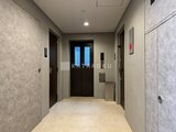 デュオメゾン西新宿 エレベーターホールから玄関へ向かう明るく落ち着いた共用廊下