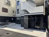 エルファーロ神宮前5 黒を基調としたモダンなエントランスと駐車スペースの様子
